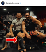 Conor McGregor siting down wearing Top King shin guards. 