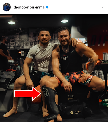 Conor McGregor siting down wearing Top King shin guards. 