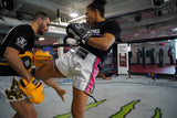 UFC fighter Dione Barbosa and trainer Matheus Naccache wearing Top King USA Gear - Top King White and Pink Muay Thai shorts, Black top king t-shirt