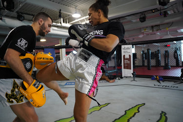 UFC fighter Dione Barbosa and trainer Matheus Naccache wearing Top King USA Gear - Top King White and Pink Muay Thai shorts, Black top king t-shirt